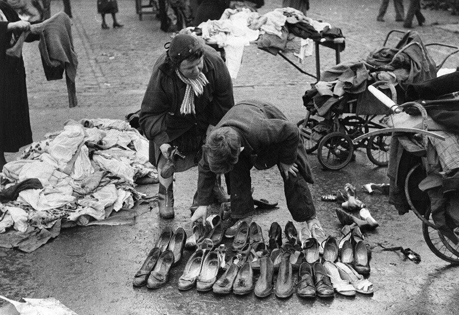 1957. Used shoe vendors on the streets of Liverpool.