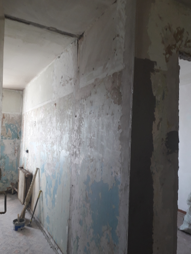 После того, как я сняла старые покрытия, прогрунтовала, на наружные углы установила металлические уголки, в том числе и у входной двери, так как ее менять они не будут, затем все стены визуально выровняла штукатуркой.   