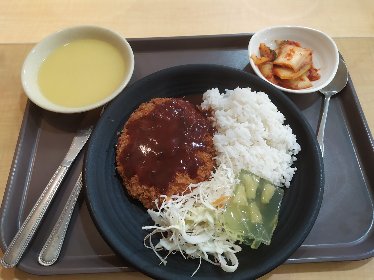 Корейская котлета, рис, капуста, желе, кимчи и что-то типа жидкой каши (сверху слева). Цена 4.5 $