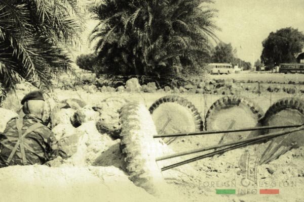 Легионер 2ой роты  REP в пальмовой роще смотрит на угнанный автобус (крайний справа).