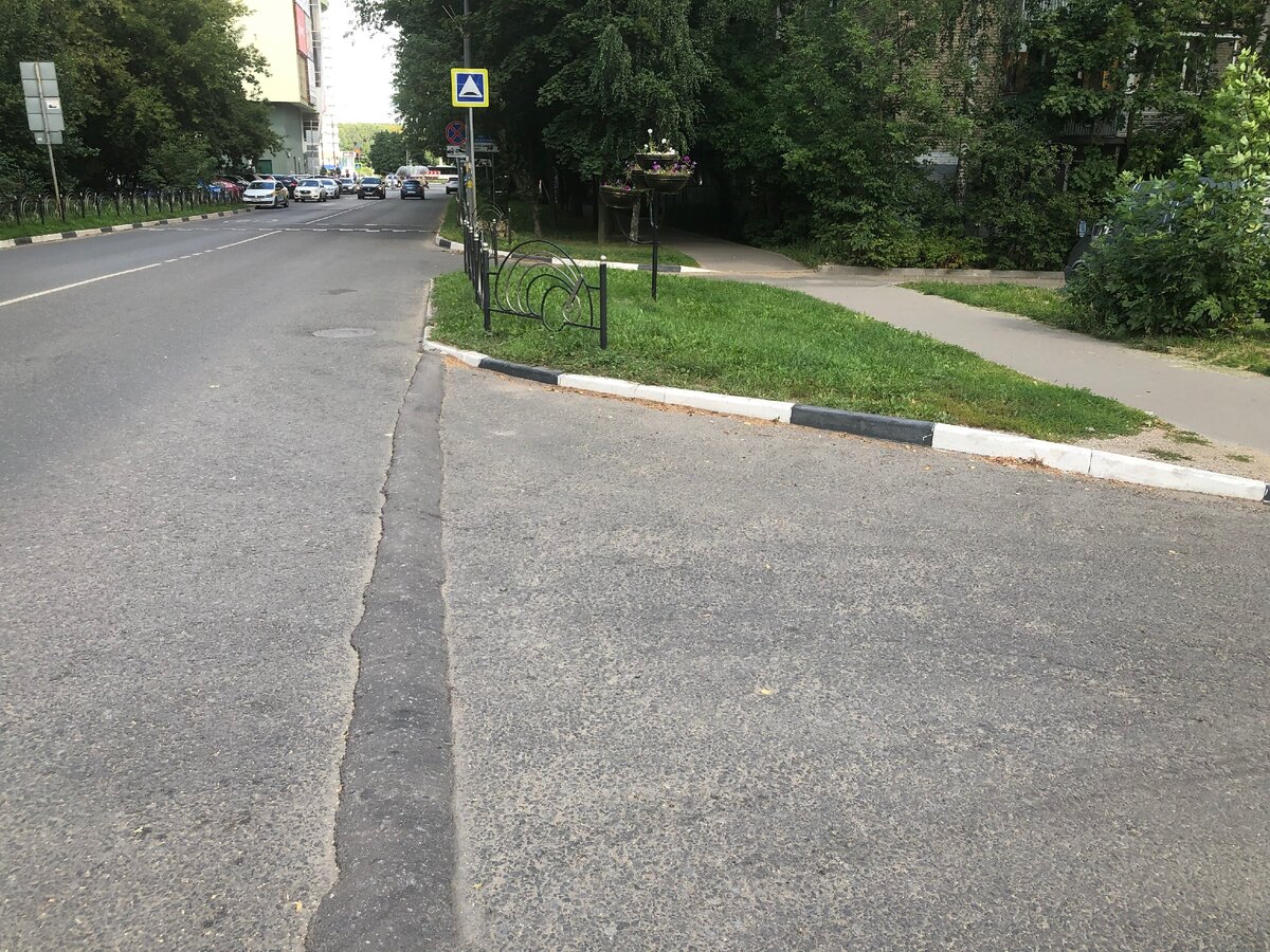 А вот пример лежачего "полицейского", расположенного прямо на повороте. И это вообще жесть. Во-первых, полицейский узкий и очень высокий, автомобилисты понимают, как это плохо для машины. Во-вторых, он находится прямо на повороте, и машины, заезжающие во двор, просто не могут нормально въехать на такое препятствие. Даже на самой маленькой скорости машина идет враскачку. Да и выезжающим из двора машинах очень неудобно, потому что они стоят перед этим "полицейским", ожидая "окна", а потом им надо быстро выехать на дорогу, но "полицейский" мешает это сделать. Такой "полицейский" реально создает опасную ситуацию на дороге. И ведь можно было расположить этого "полицейского" метров на десять дальше, во двор. Но нет, сделали, не думая. Кстати, это фото сделал тоже в Пушкине. Но в других городах тоже таких ситуаций хватает. Фото автора