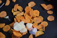 Сперва нужно нашинковать очищенную морковку и чеснок тонкими слайсами. Пассеровать рубленые овощи на растительном масле.