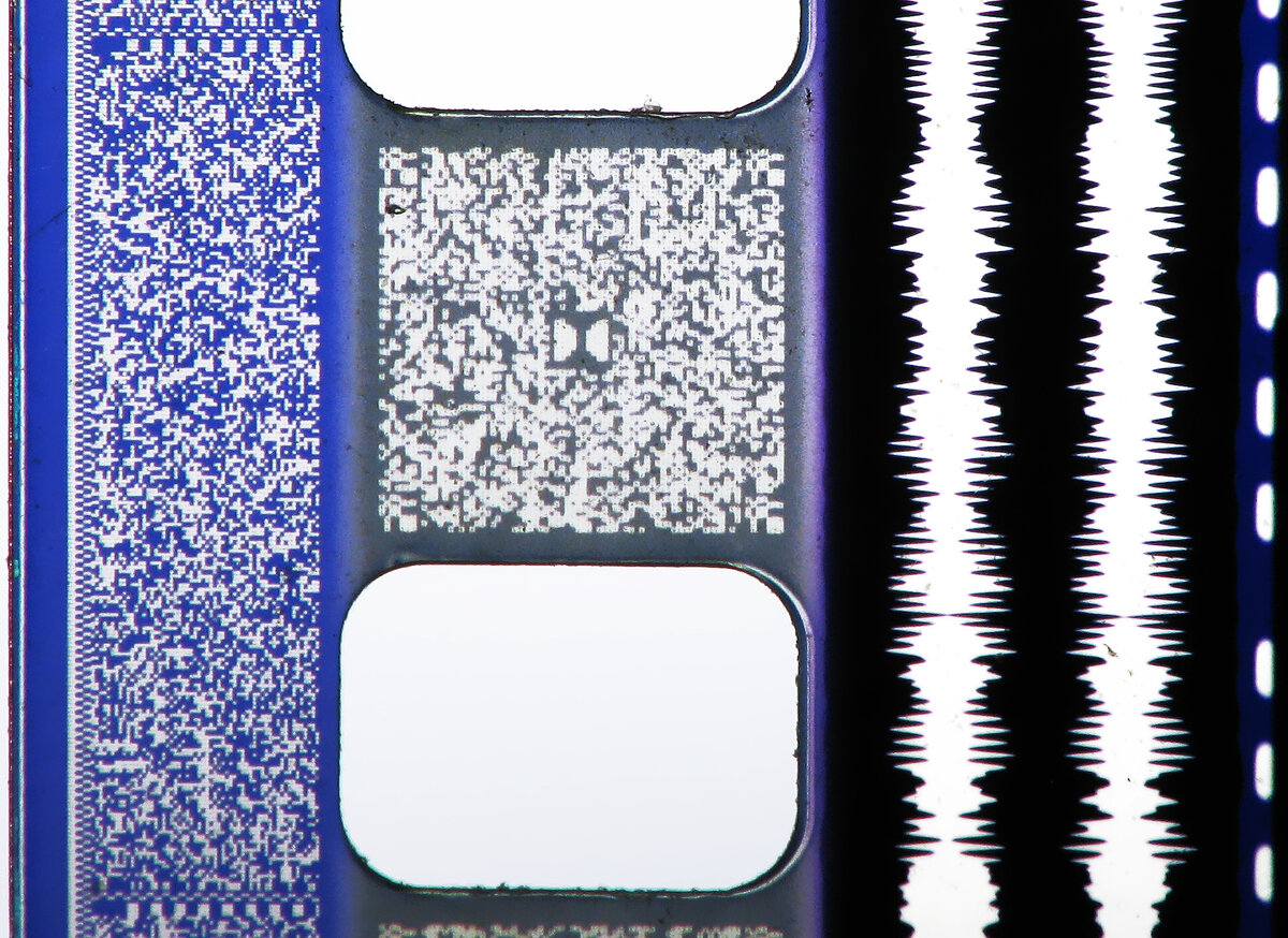 Для тех кто не знает, что такое оптическая звуковая дорожка, вставлю картиночку из Википедии. Вот она та самая звуковая дорожка в правой части картинки, так с давних времен записывался звук на кинопленку.

