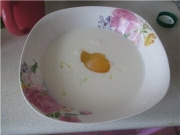 В глубокой посуде хорошо смешаем кефир и яйцо.