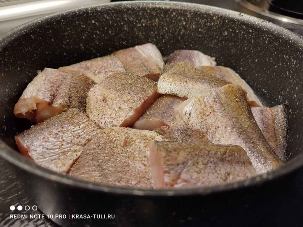 Размороженный хек в сотейнике с перцем и солью