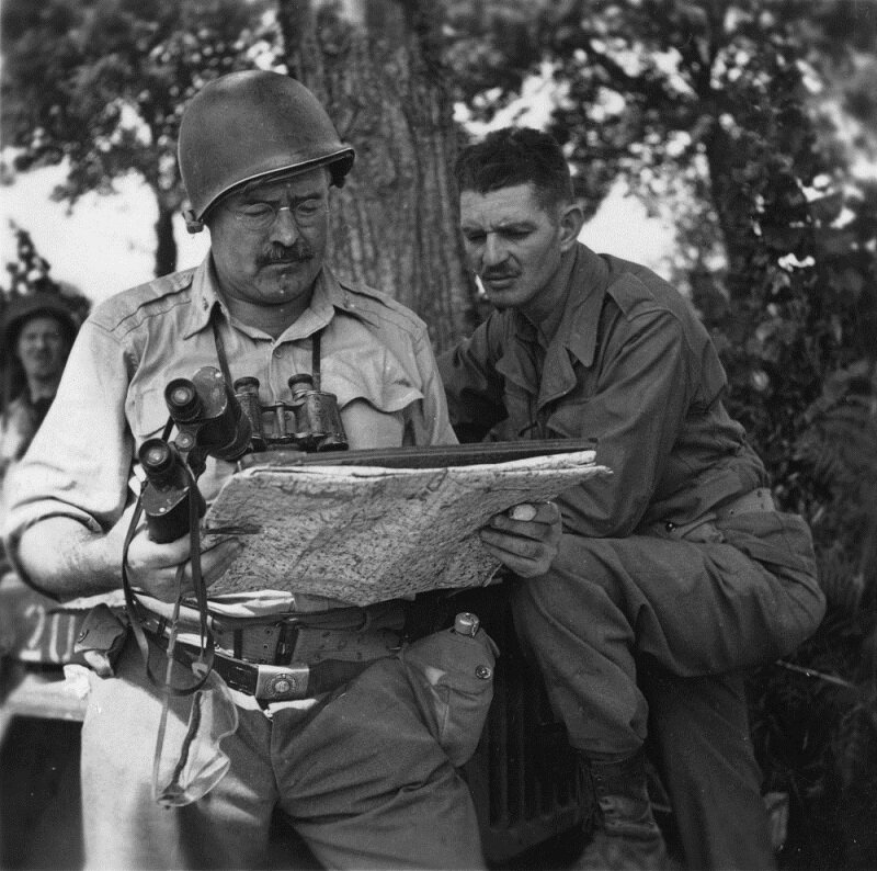 EH6891P  Ernest Hemingway with soldier looking at a map in World War II.  Photograph coopyright unknown and held in the Ernest Hemingway Collection at the John F. Kennedy Presidential Library and Museum, Boston.