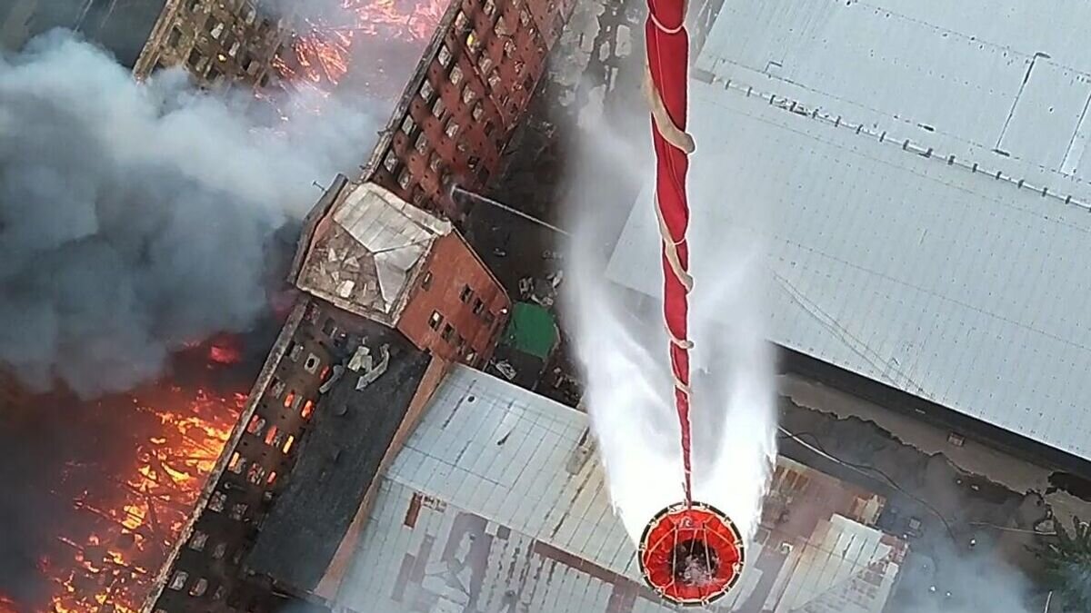    Сброс воды с вертолета Ми-8 Западного военного округа на горящее здание фабрики "Невская мануфактура" на Октябрьской набережной в Санкт-Петербурге. Кадр видео© РИА Новости / Пресс-служба Минобороны РФ