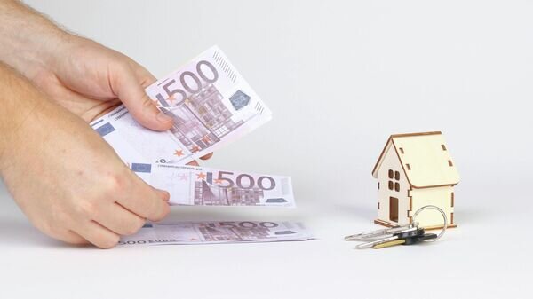    CC BY 2.0 / Marco Verch Professional Photographer / Man counting money with tiny wooden house and keys