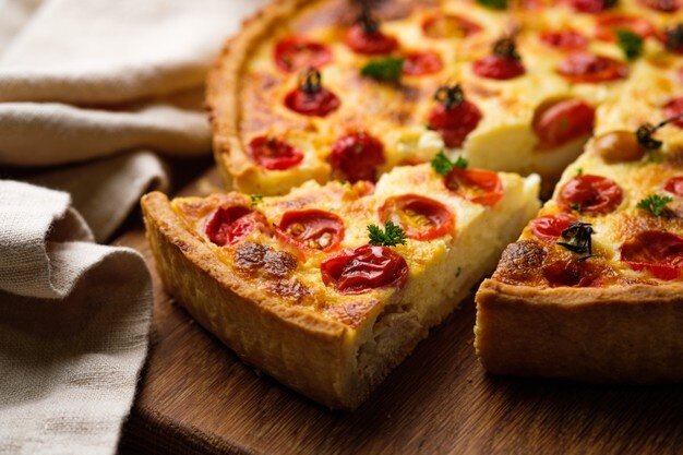 https://img.freepik.com/free-photo/quiche-with-chicken-cherry-tomatoes-cheese-appetizing-open-french-pie-dish-wooden-board-kitchen-table-horizontally_166262-1098.jpg?size=626&ext=jpg&ga=GA1.2.1949926782.1639180800