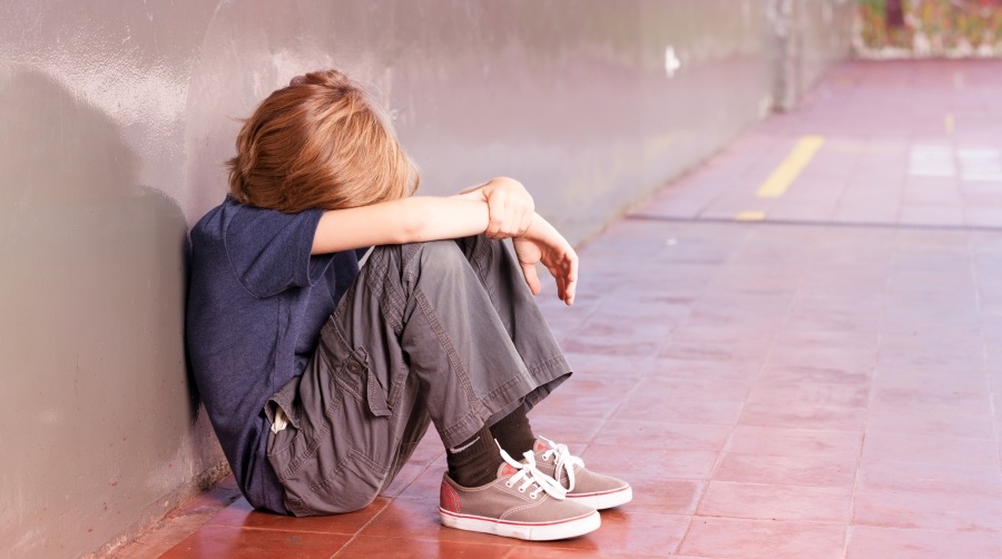    Primary school child alone at school. Isolation concept