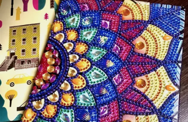 Альбом для рисования, обложка которого украшена неполной выкладкой стразами