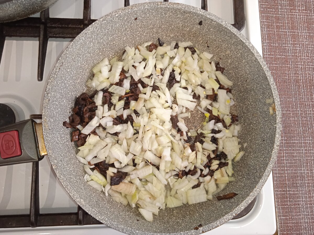 В сковороду к  грибам добавляю измельчённый лук и обжариваю до зарумянивания.