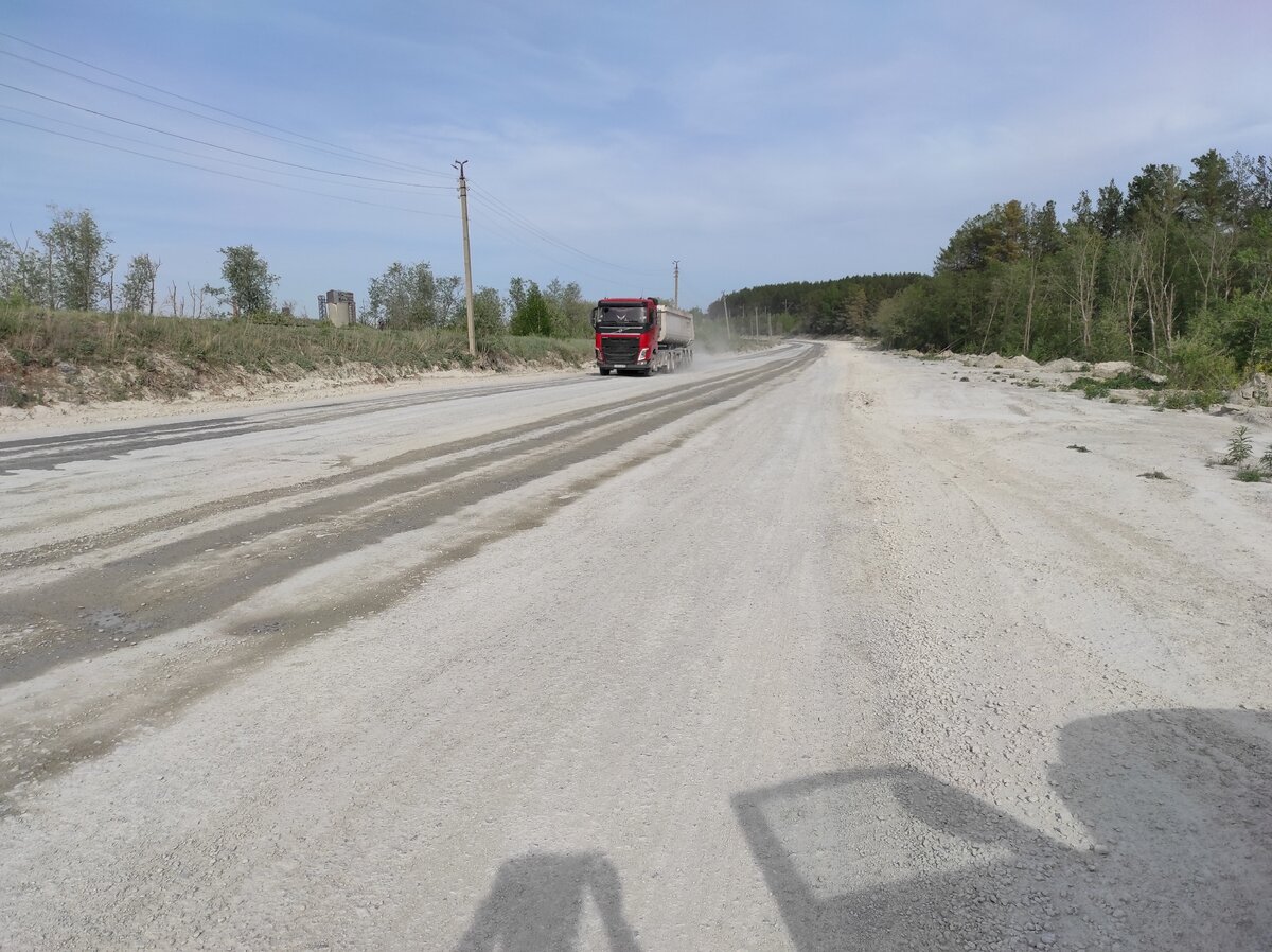 Дорога мокрая в сухой жаркий день, потому что ее поливают во избежание  пыления 