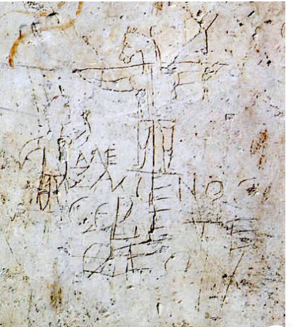 Граффито Алексамена. Карикатура, нацарапанная на одном из зданий на восточном склоне Палатинского холма в Риме. Изображение распятого Иисуса Христа с головой осла, внизу почитатель христианства, по-видимому, Алексамен. Надпись гласит: "Алексамен поклоняется своему богу". Дата написания может быть от конца l до начала lll века, скорее всего начало lll века.