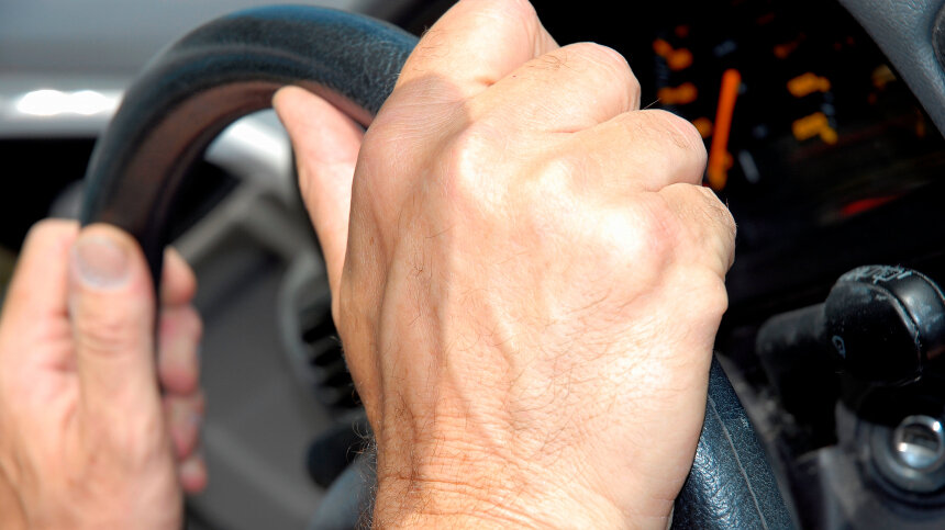 Премия за рулем. Hands on Steering Wheel. Muscular hand on Steering Wheel. Even Wheel.