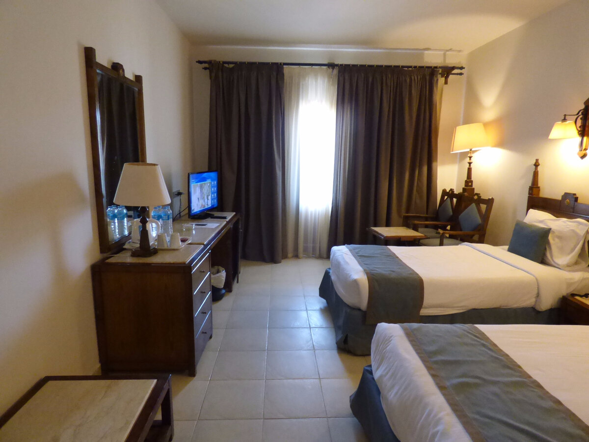 Fig. 3. Egypt, Hurghada, Sunny Days El Palacio Resort & Spa, room 5210, table, TV, two beds.
