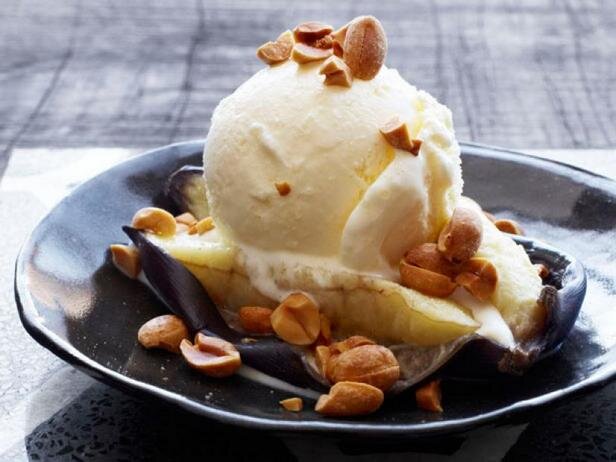 Несмотря на то, что бананы это фрукты, они настолько сладкие, что могут стать полноценным десертом. Особенно если запечь их в духовке. Тогда природная банановая сладость станет ещё интенсивней, останется только разрезать фрукт, дополнить шариком мороженого и посыпать порубленным арахисом. Отличный полезный десерт без искусственных добавок на скорую руку. 