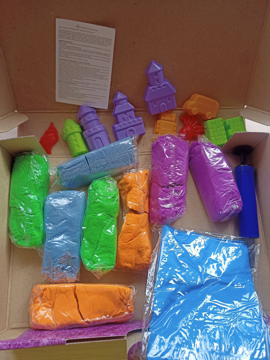 Картонная коробка. Внутри 4 цвета кинетического песка, формочки, песочница и насос