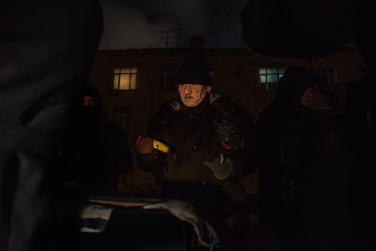 Бездомные получают продукты от волонтеров на точке за площадью трех вокзалов