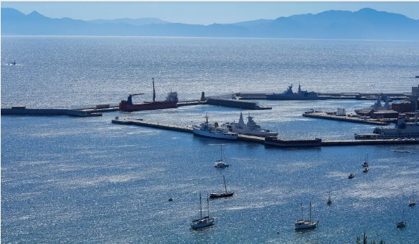 Российский контейнеровоз, находящийся под санкциями, слева в центре, пришвартовался в военно-​морском порту Южной Африки недалеко от Кейптауна в прошлом месяце