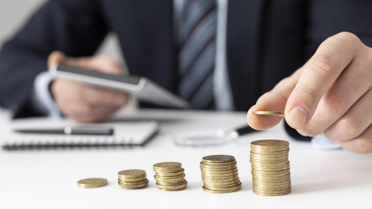    Мужчина складывает монеты в столбики:freepik.com