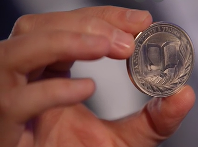 Вид серебряной медали нового образца из рук министра просвещения