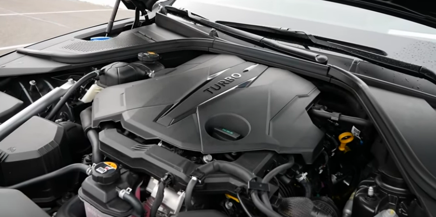 Подкапотное пространство вместе с двигателем с рабочим объемом на 3,5 литра в комплектации 3,5T Sport. Это автомобиль Genesis G80 2022 года.