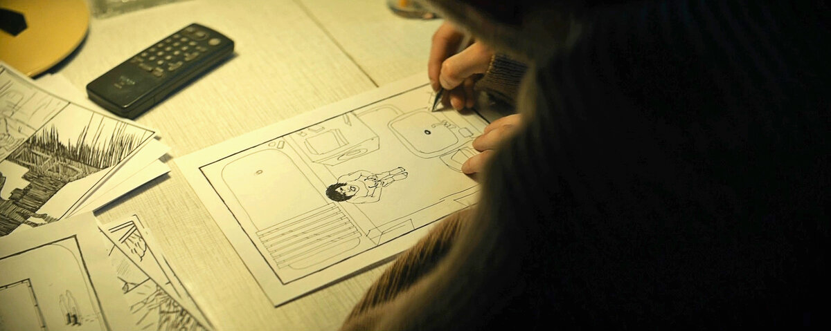 Петров рисует комикс, где мы видим кадр из фильма.