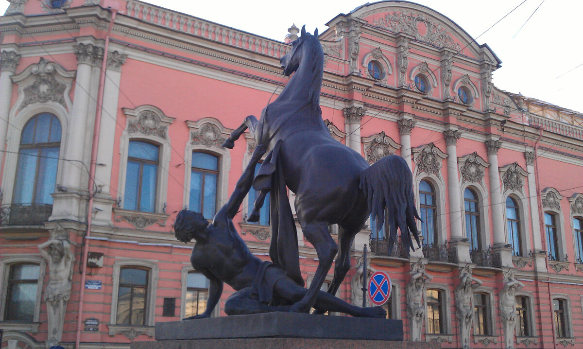 Одна из скульптур П.Клодта "Укрощение коня. Юноша поверженный конём" (1950) на Аничковом мосту на фоне Дворца Белосельских-Белозерских. 