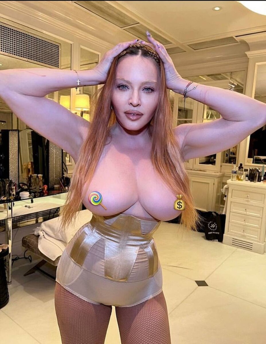 Madonna poses topless