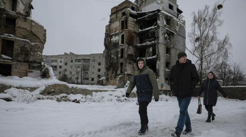Зимняя прогулка рядом с разрушенными зданиями в украинском поселке Бородянка © Jeff J Mitchell/AFP/Getty Images