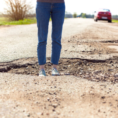    bad roads - a girl stands in a hole in the road Валерий