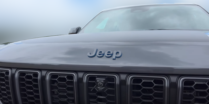 Маркировка бренда на капоте с голубой тенью, котороя говорит о наличии в комплектации гибридного двигателя.