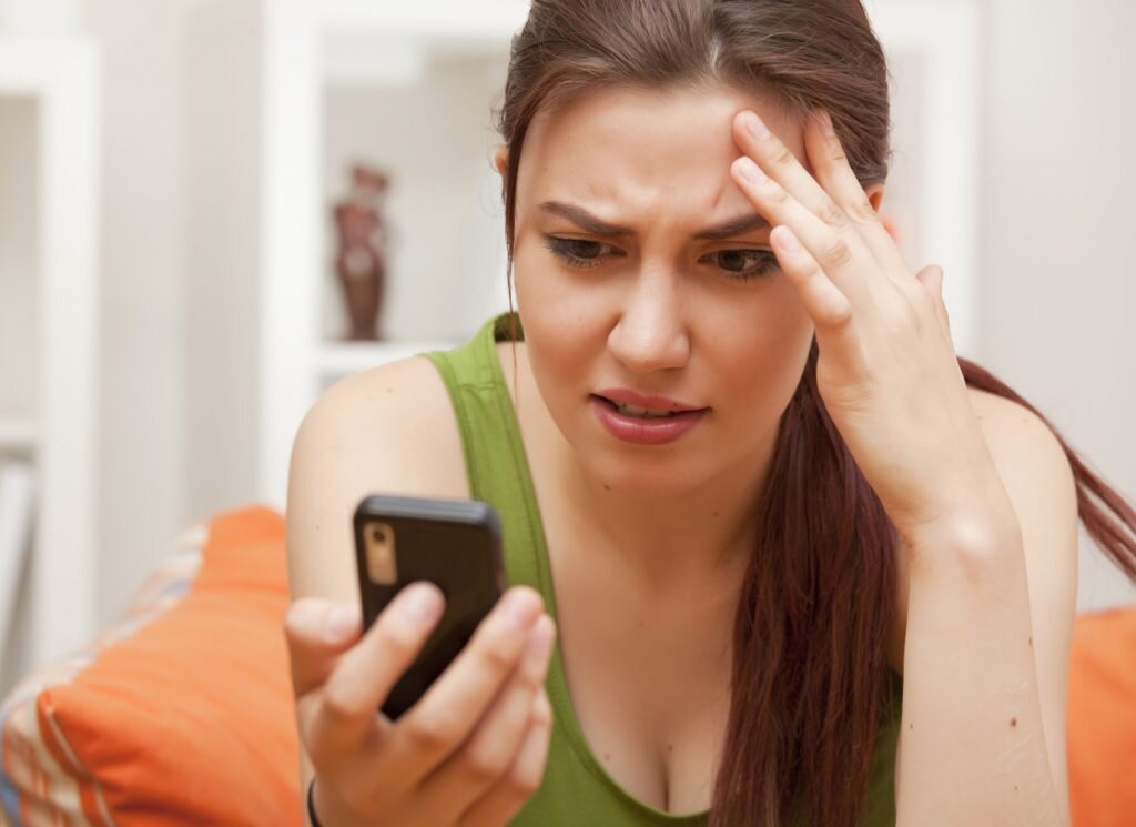   shocked and frustrated woman with cellphone; Shutterstock ID 79595149; PO: The Huffington Post; Job: The Huffington Post; Client: The Huffington Post; Other: The Huffington Post Irina