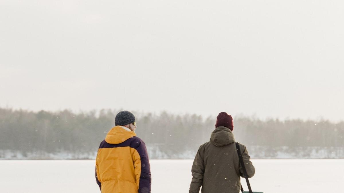    Двое мужчин в куртках идут по заснеженной местности:pexels.com