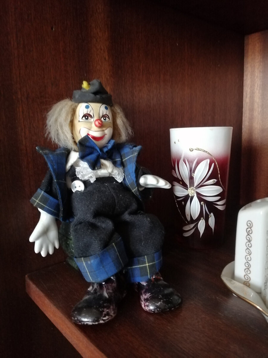 клоун фарфоровый, местами разбит и склеен, но сохранился. Раньше стоял, сейчас может только сидеть