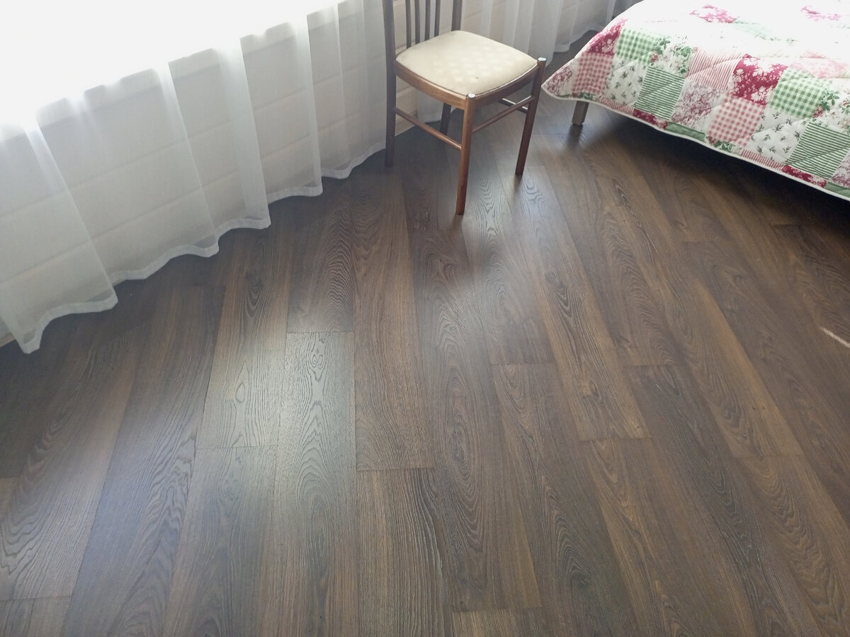 Вдоль стены отступаем 10 см. Кровать на ножках, значит пол можно укладывать.