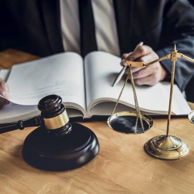    Male lawyer or judge working with contract papers, Law books and wooden gavel on table in courtroom, Justice lawyers at law firm, Law and Legal services concept. Валерий