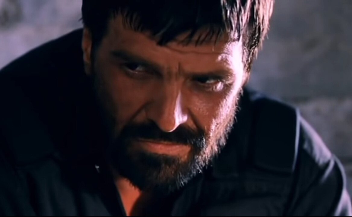 Хасан Исмаилов. Командир отряда боевиков. (Кадр из фильма).