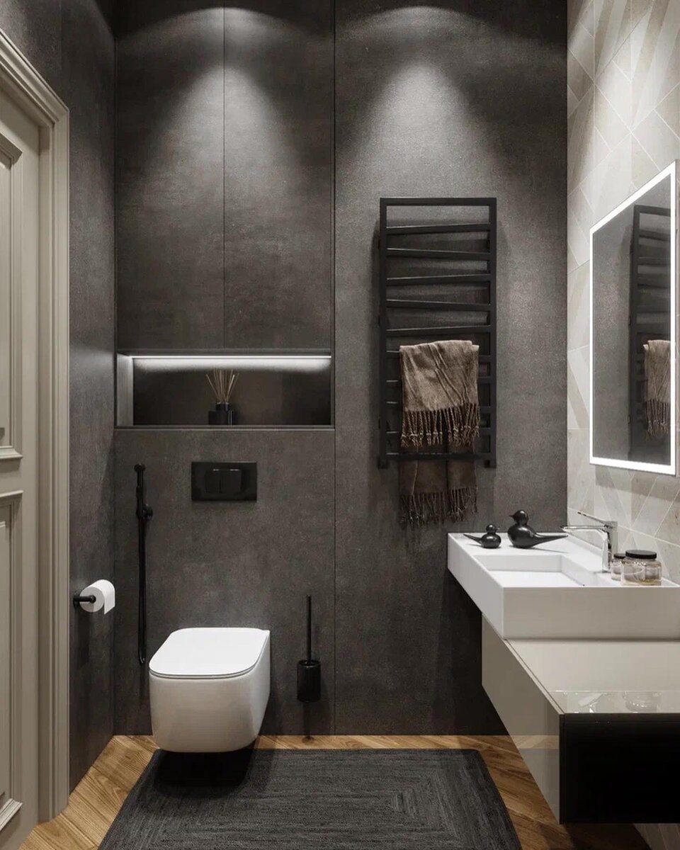 Текстура под бетон, в сочетании с чёрными аксессуарами, смотрятся очень стильно. А крупногабаритные плиты керамогранита создают ощущение монолитности стены, с минимальным количеством стыков