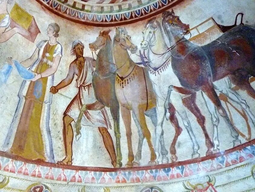 Конюх, держащий лошадей.