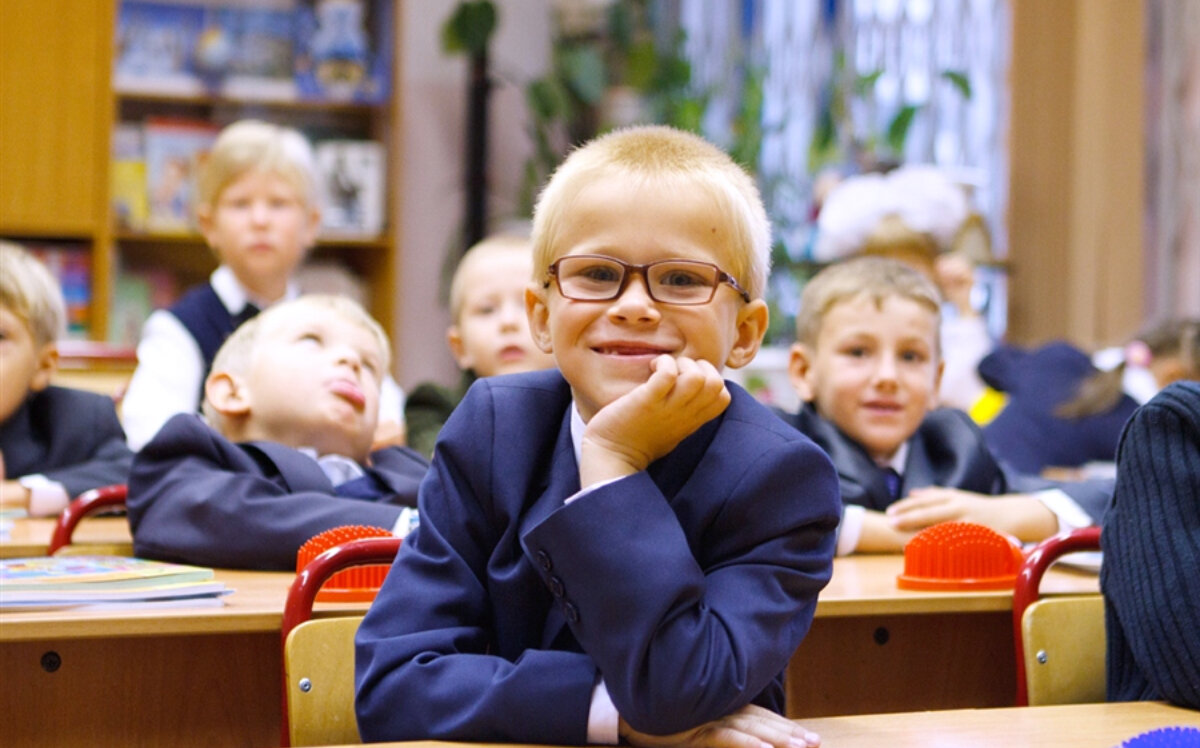 Ребёнок в очках на первой парте. Источник: lifeisphoto.ru