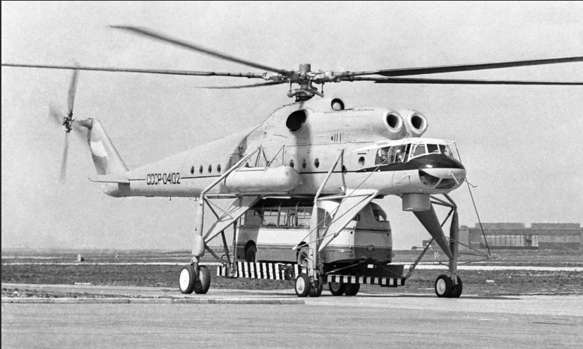 Ми-10, он же летающий кран. Разрабатывался на базе Ми-6 и имел, конечно, военные специальности, но наиболее известной стала модификация Ми-10К, предназначенная для выполнения различных строительно-монтажных работ. Оба вертолета выпускались Ростовским заводом, ныне ПАО "Росвертол", который в лихие 90-е фактически спас КБ Миля от разорения и ликвидации "западными партнерами" выкупив часть акций.