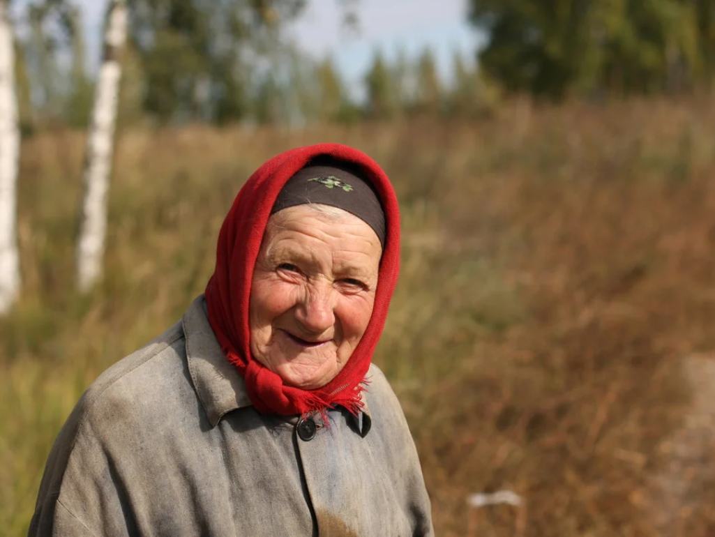 Нашлась пожилая женщина. Деревенская бабушка. Бабушка улыбается. Старуха в платке. Бабуля в платке.