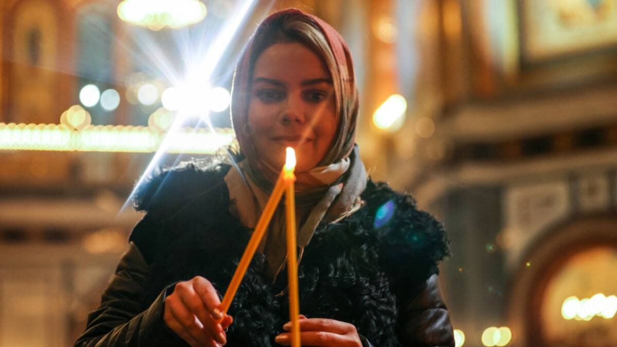    Прихожанка во время богослужения в храме Христа Спасителя / Фото: Сергей Бобылев / ТАСС