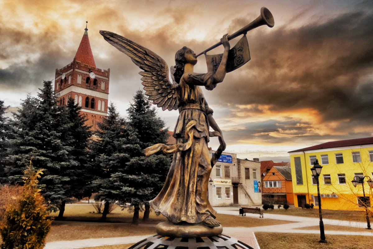 Памятник "Ангел мира" в Правдинске, на заднем плане - бывшая кирха Фридланда. 