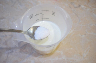 ШАГ 1:
Как сделать оладьи на кефире без дрожжей? Подготовьте продукты. Нагрейте кефир до теплого состояния и добавьте в него соду. Перемешайте и оставьте постоять на 3-5 минут. За это время сода вступит в реакцию с кефиром. Благодаря этому готовые оладьи и будут пышные.