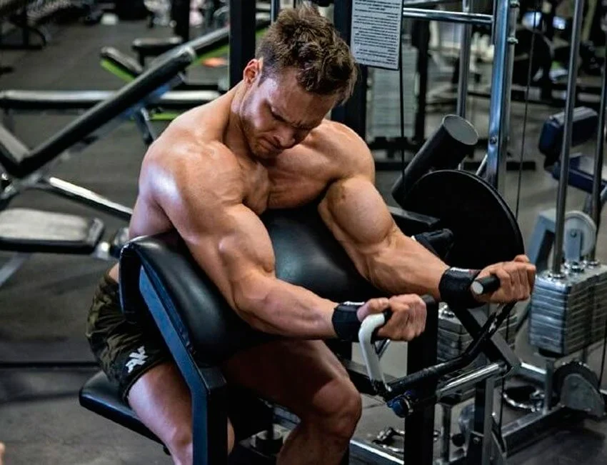 Тренировка машины. Подъем на бицепс в тренажере Скотта. Упражнения на бицепс на тренажере. Упражнение на битепсв тренажере. Сгибание рук в тренажере.