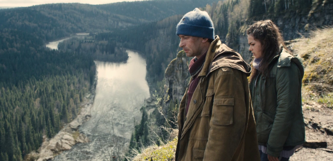 Географ Служкин (К. Хабенский) и Маша (А. Черных) наблюдают за сплавом через пороги своих товарищей на реке.