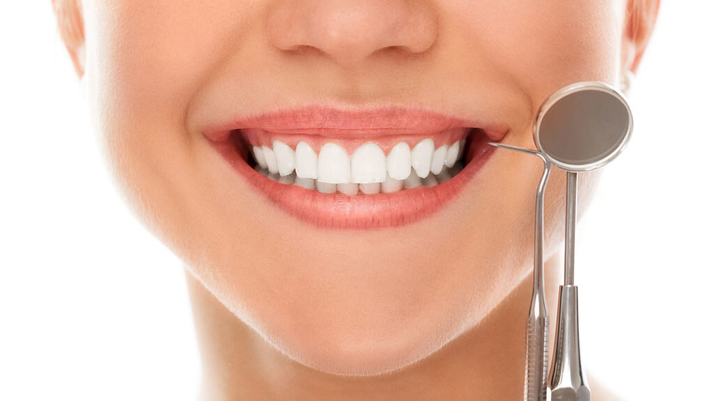    A woman is smiling while being at the dentist Александр Шереметьев